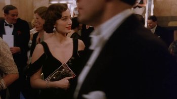 Movie still from “A Handful of Dust” (1988), directed by Charles Sturridge – A woman in a black dress and a man in a black suit; Medium shot, Over the shoulder angle