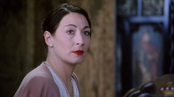 Movie still from “A Handful of Dust” (1988), directed by Charles Sturridge – A person wearing a dress; Close Up shot, Over the shoulder angle