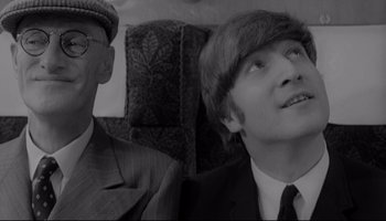 Movie still from “A Hard Day's Night” (1964), directed by Richard Lester – A man in a suit sitting next to an older man in a tie; Close Up shot, Over the shoulder angle