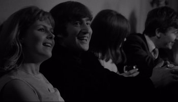 Movie still from “A Hard Day's Night” (1964), directed by Richard Lester – A group of people sitting next to each other in a room; Close Up shot, Over the shoulder angle