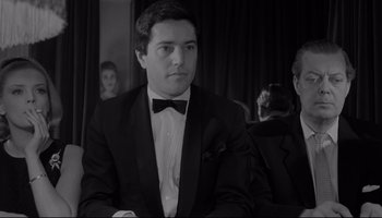 Movie still from “A Hard Day's Night” (1964), directed by Richard Lester – A man in a tuxedo sitting in a room; Medium shot, Over the shoulder angle