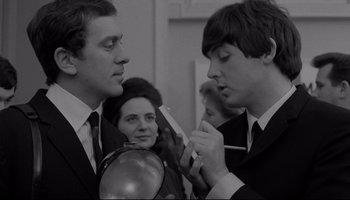 Movie still from “A Hard Day's Night” (1964), directed by Richard Lester – Two men and a woman in suits and ties; Close Up shot, Over the shoulder angle