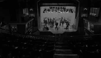 Movie still from “A Hard Day's Night” (1964), directed by Richard Lester – An overhead view of a stage with people on it; Extreme Wide shot, High angle
