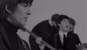 Movie still from “A Hard Day's Night” (1964), directed by Richard Lester – A group of young men playing instruments in a room; Close Up shot, Low angle