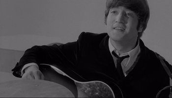 Movie still from “A Hard Day's Night” (1964), directed by Richard Lester – A young man sitting in front of a guitar; Close Up shot, High angle