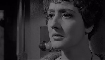 Movie still from “A Hard Day's Night” (1964), directed by Richard Lester – A woman's face in a black - and - white photo; Close Up shot, Low angle