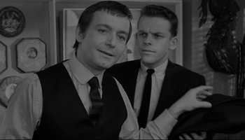 Movie still from “A Hard Day's Night” (1964), directed by Richard Lester – Two young men posing for a picture in black and white; Close Up shot, Over the shoulder angle