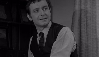 Movie still from “A Hard Day's Night” (1964), directed by Richard Lester – A black and white photo of a man wearing a vest and tie; Close Up shot, Low angle