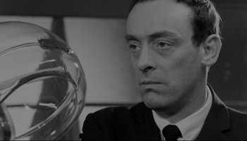 Movie still from “A Hard Day's Night” (1964), directed by Richard Lester – Black and white photograph of a man in a suit; Close Up shot, Low angle