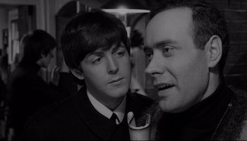 Movie still from “A Hard Day's Night” (1964), directed by Richard Lester – A man and a boy in a suit and tie; Close Up shot, Over the shoulder angle