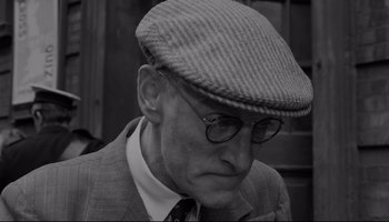 Movie still from “A Hard Day's Night” (1964), directed by Richard Lester – An older man wearing glasses and a hat; Close Up shot, Low angle