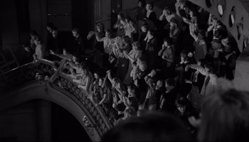Movie still from “A Hard Day's Night” (1964), directed by Richard Lester – A group of people sitting on a stage; Extreme Wide shot, High angle