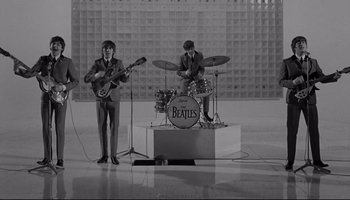 Movie still from “A Hard Day's Night” (1964), directed by Richard Lester – A couple of people that are playing some instruments; Extreme Wide shot, High angle