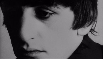 Movie still from “A Hard Day's Night” (1964), directed by Richard Lester – A black and white photo of a young man's face; Close Up shot, Low angle