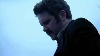 Movie still from “A Horrible Way to Die” (2010), directed by Adam Wingard – A person wearing a jacket; Close Up shot, Low angle