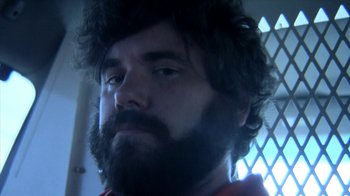 Movie still from “A Horrible Way to Die” (2010), directed by Adam Wingard – A person with a beard; Close Up shot, Low angle