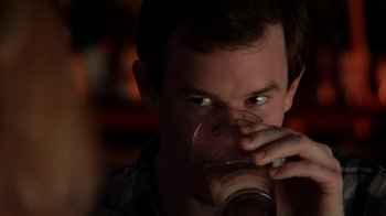 Movie still from “A Horrible Way to Die” (2010), directed by Adam Wingard – A man drinking a beverage from a glass; Close Up shot, Over the shoulder angle