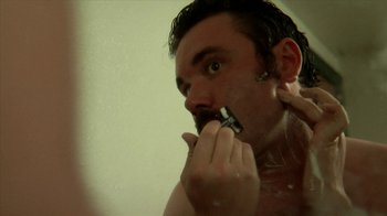 Movie still from “A Horrible Way to Die” (2010), directed by Adam Wingard – A man brushing his teeth in the bathroom; Close Up shot, Over the shoulder angle