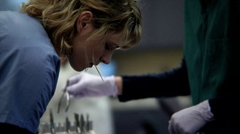 Movie still from “A Horrible Way to Die” (2010), directed by Adam Wingard – A woman looking down at a pair of white gloves; Extreme Close Up shot, Low angle