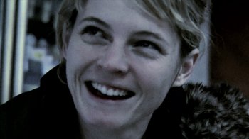 Movie still from “A Horrible Way to Die” (2010), directed by Adam Wingard – A person with a smile on their face; Extreme Close Up shot, Low angle
