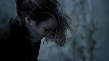 Movie still from “A Horrible Way to Die” (2010), directed by Adam Wingard – A young woman with long dark brown hair blowing in the wind; Close Up shot, Over the shoulder angle