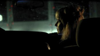 Movie still from “A Horrible Way to Die” (2010), directed by Adam Wingard – A woman sitting in the back seat of a car at night; Close Up shot, Over the shoulder angle