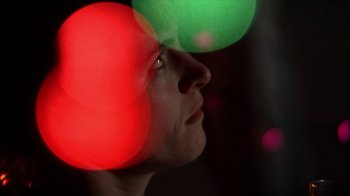 Movie still from “A Horrible Way to Die” (2010), directed by Adam Wingard – A man looking up into the air with a red light in the background; Extreme Close Up shot, Low angle