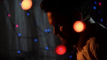 Movie still from “A Horrible Way to Die” (2010), directed by Adam Wingard – A person with lights in the background; Extreme Close Up shot, Low angle