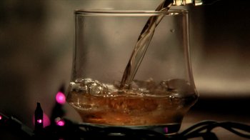 Movie still from “A Horrible Way to Die” (2010), directed by Adam Wingard – A glass of water is being poured into a glass; Extreme Close Up shot, Overhead angle