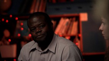 Movie still from “A Horrible Way to Die” (2010), directed by Adam Wingard – A man in a white dress shirt is in front of a book shelf; Close Up shot, Low angle