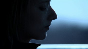 Movie still from “A Horrible Way to Die” (2010), directed by Adam Wingard – A woman's face in the dark; Close Up shot, Low angle