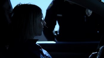 Movie still from “A Horrible Way to Die” (2010), directed by Adam Wingard – A woman sitting in front of a police officer; Close Up shot, Over the shoulder angle