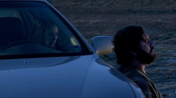 Movie still from “A Horrible Way to Die” (2010), directed by Adam Wingard – A woman sitting in the passenger seat of a white car; Medium shot, Low angle