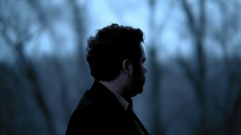 Movie still from “A Horrible Way to Die” (2010), directed by Adam Wingard – A person wearing a suit and tie; Close Up shot, Over the shoulder angle