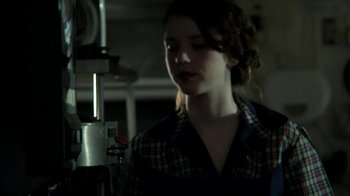 Movie still from “A Horrible Way to Die” (2010), directed by Adam Wingard – A woman standing in front of an industrial machine; Close Up shot, Low angle