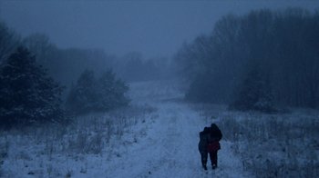 Movie still from “A Horrible Way to Die” (2010), directed by Adam Wingard – Two people are walking in the snow on a hill; Extreme Wide shot, High angle