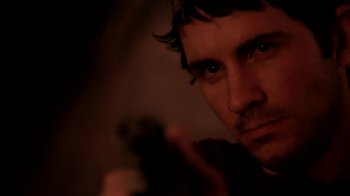 Movie still from “A Horrible Way to Die” (2010), directed by Adam Wingard – A person holding a gun; Close Up shot, Over the shoulder angle