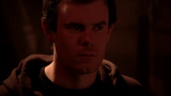 Movie still from “A Horrible Way to Die” (2010), directed by Adam Wingard – A person wearing a black t - shirt; Close Up shot, Low angle