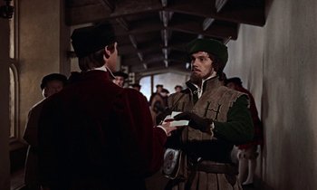 Movie still from “A Man for All Seasons” (1966), directed by Fred Zinnemann – Two men in medieval garb talking to each other; Medium shot, Over the shoulder angle