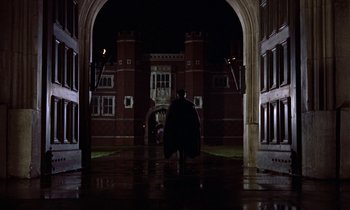 Movie still from “A Man for All Seasons” (1966), directed by Fred Zinnemann – A man in a cape walking through an archway at night; Extreme Wide shot, Low angle