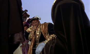 Movie still from “A Man for All Seasons” (1966), directed by Fred Zinnemann – A group of people dressed in medieval clothing; Medium shot, Over the shoulder angle