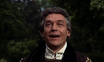 Movie still from “A Man for All Seasons” (1966), directed by Fred Zinnemann – An older man in a black jacket and white shirt; Close Up shot, Low angle