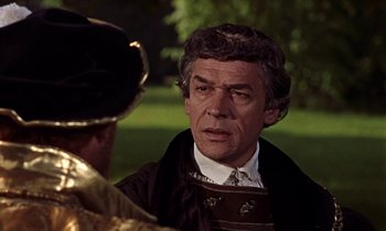 Movie still from “A Man for All Seasons” (1966), directed by Fred Zinnemann – An older man wearing a suit and tie talking to another man in a suit; Close Up shot, Over the shoulder angle