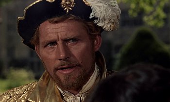Movie still from “A Man for All Seasons” (1966), directed by Fred Zinnemann – A person with a beard wearing a hat; Close Up shot, Over the shoulder angle