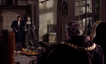 Movie still from “A Man for All Seasons” (1966), directed by Fred Zinnemann – A woman dressed in medieval garb standing in front of an older man; Wide shot, Over the shoulder angle