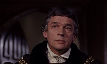 Movie still from “A Man for All Seasons” (1966), directed by Fred Zinnemann – A person wearing a suit and tie; Close Up shot, Low angle