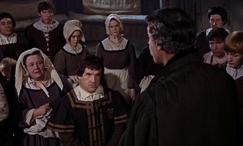 Movie still from “A Man for All Seasons” (1966), directed by Fred Zinnemann – A group of people dressed in medieval clothing; Medium shot, Over the shoulder angle