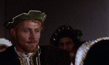 Movie still from “A Man for All Seasons” (1966), directed by Fred Zinnemann – A person with a beard wearing a hat; Close Up shot, Over the shoulder angle