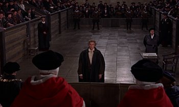 Movie still from “A Man for All Seasons” (1966), directed by Fred Zinnemann – A group of people in a room with a man in a robe; Wide shot, High angle