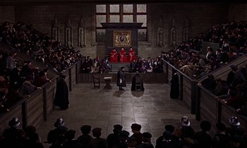 Movie still from “A Man for All Seasons” (1966), directed by Fred Zinnemann – An audience is sitting in the middle of a courtroom; Extreme Wide shot, High angle